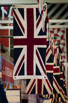 Row of British flags hanging in a market stall, showcasing national pride.